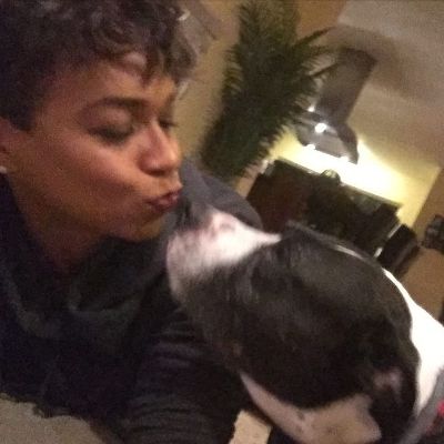 Photo of Gillian Iliana Waters kissing her late dog. 